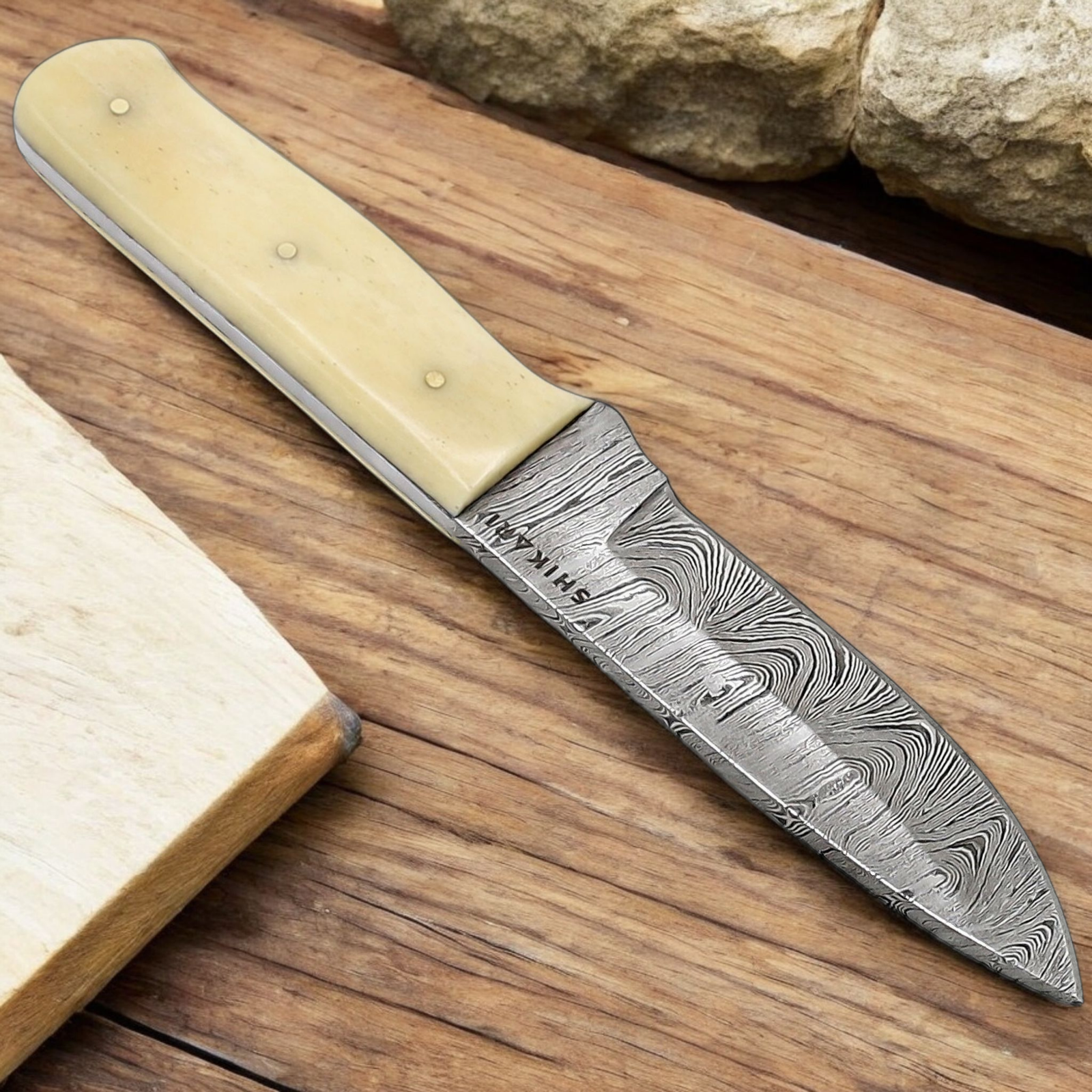 Handmade Damascus Hunting Knife with Camel Bone Handle (4) Handmade Damascus hunting knife with twist-pattern Damascus steel blade, camel bone handle, and genuine leather sheath.