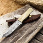 Handmade Damascus hunting knife with twist-pattern Damascus steel blade, camel bone handle, and genuine leather sheath.