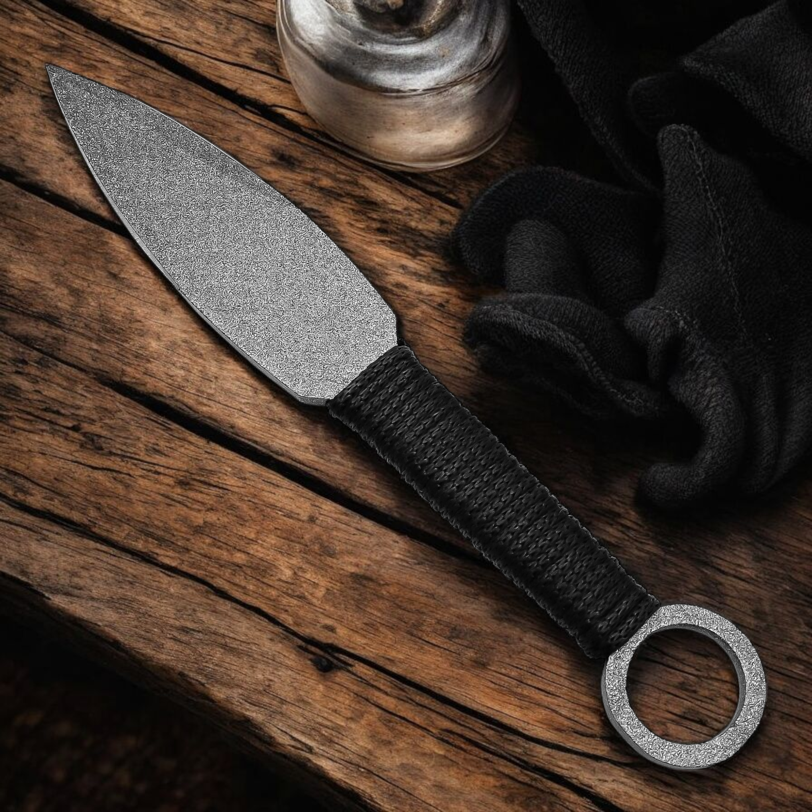 Handmade throwing knife with black wrapped handle and leather sheath