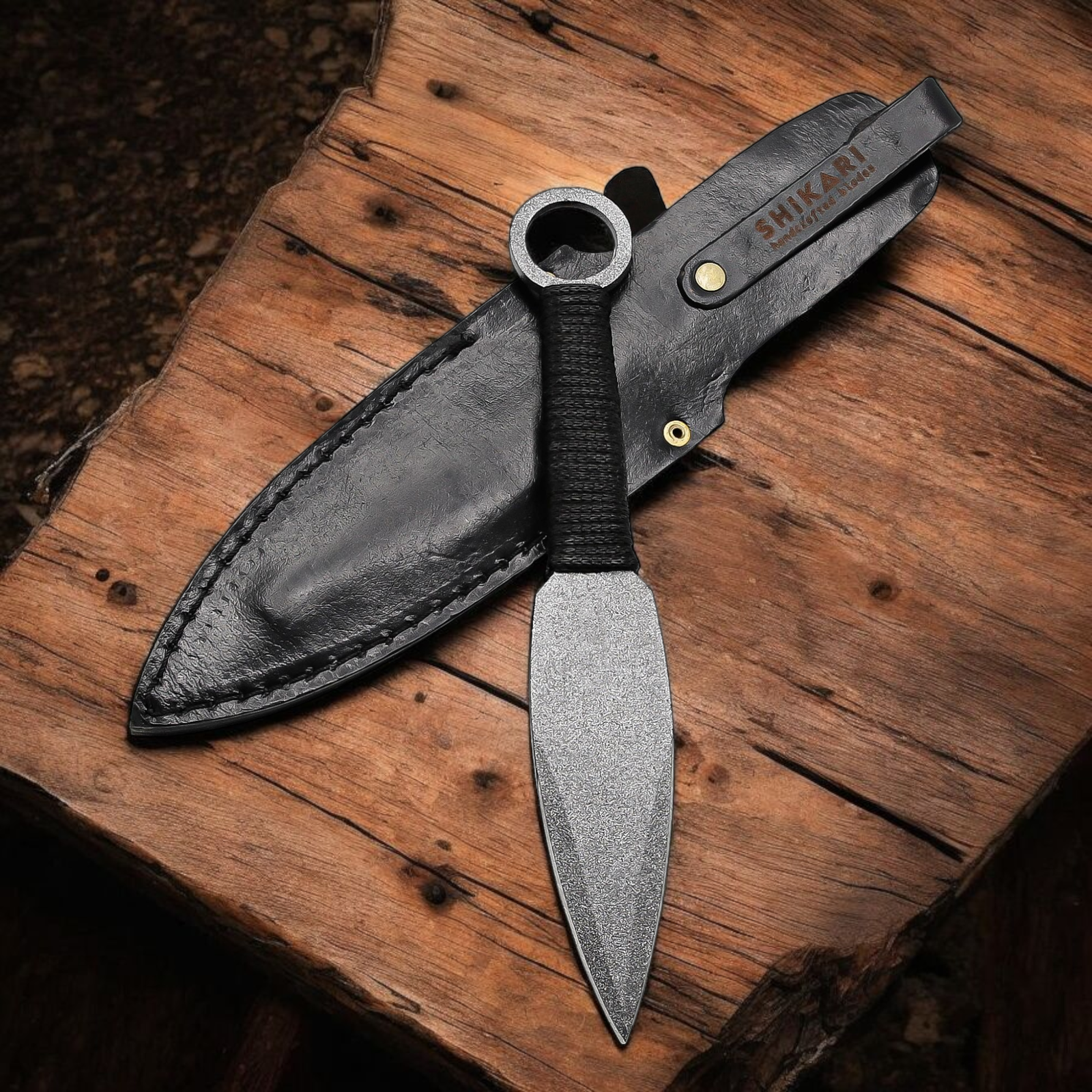 Handmade throwing knife with black wrapped handle and leather sheath